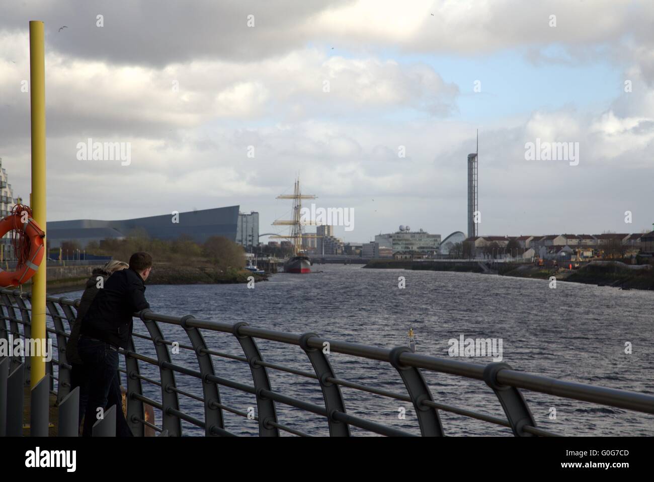 Young couple contemplate the new  river Clyde view in Glasgow, Scotland Stock Photo