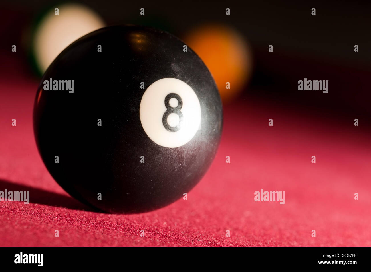 Billards pool or snooker game. The black eight ball. Red cloth table Stock Photo