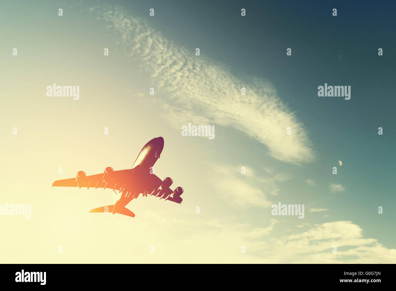 Airplane taking off at sunset. Silhouette of a big passenger or cargo aircraft Stock Photo