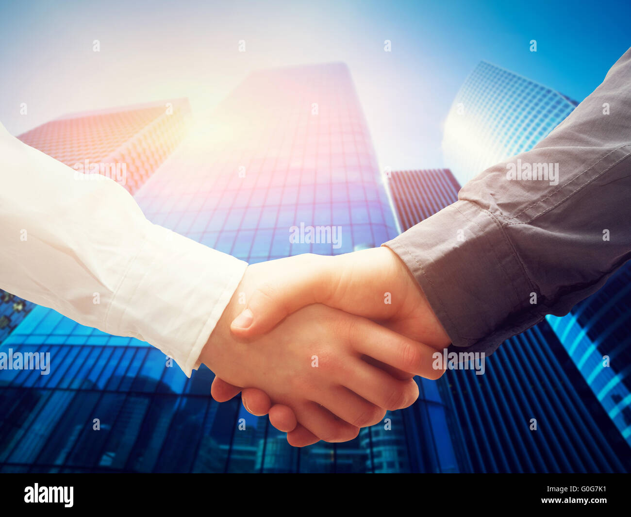 Business handshake on modern skyscrapers background. Deal Stock Photo