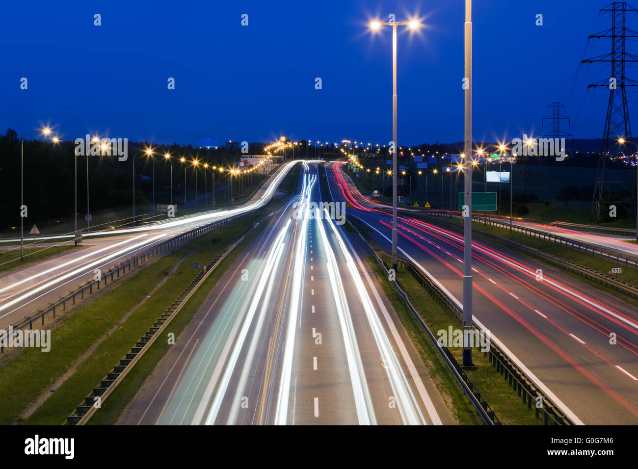 Highway traffic at the evening. Cars lights in motion on the streets. Transport Stock Photo