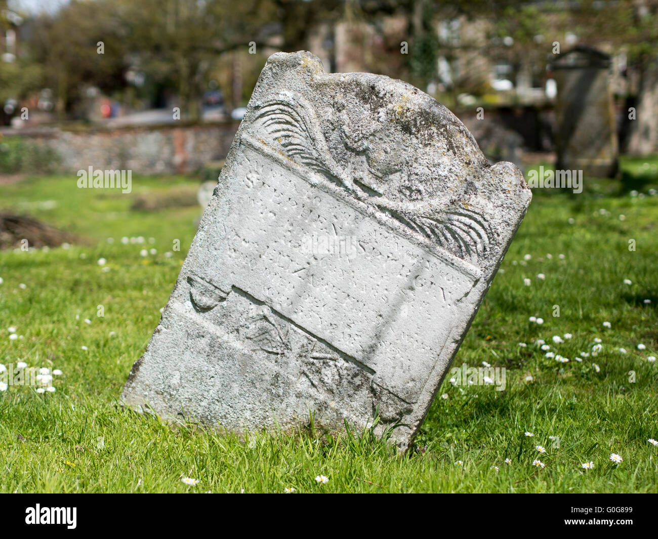 An old leaning gravestone. Stock Photo