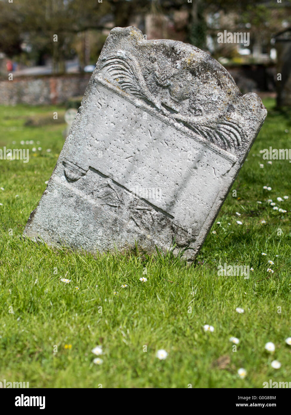 An old leaning gravestone. Stock Photo