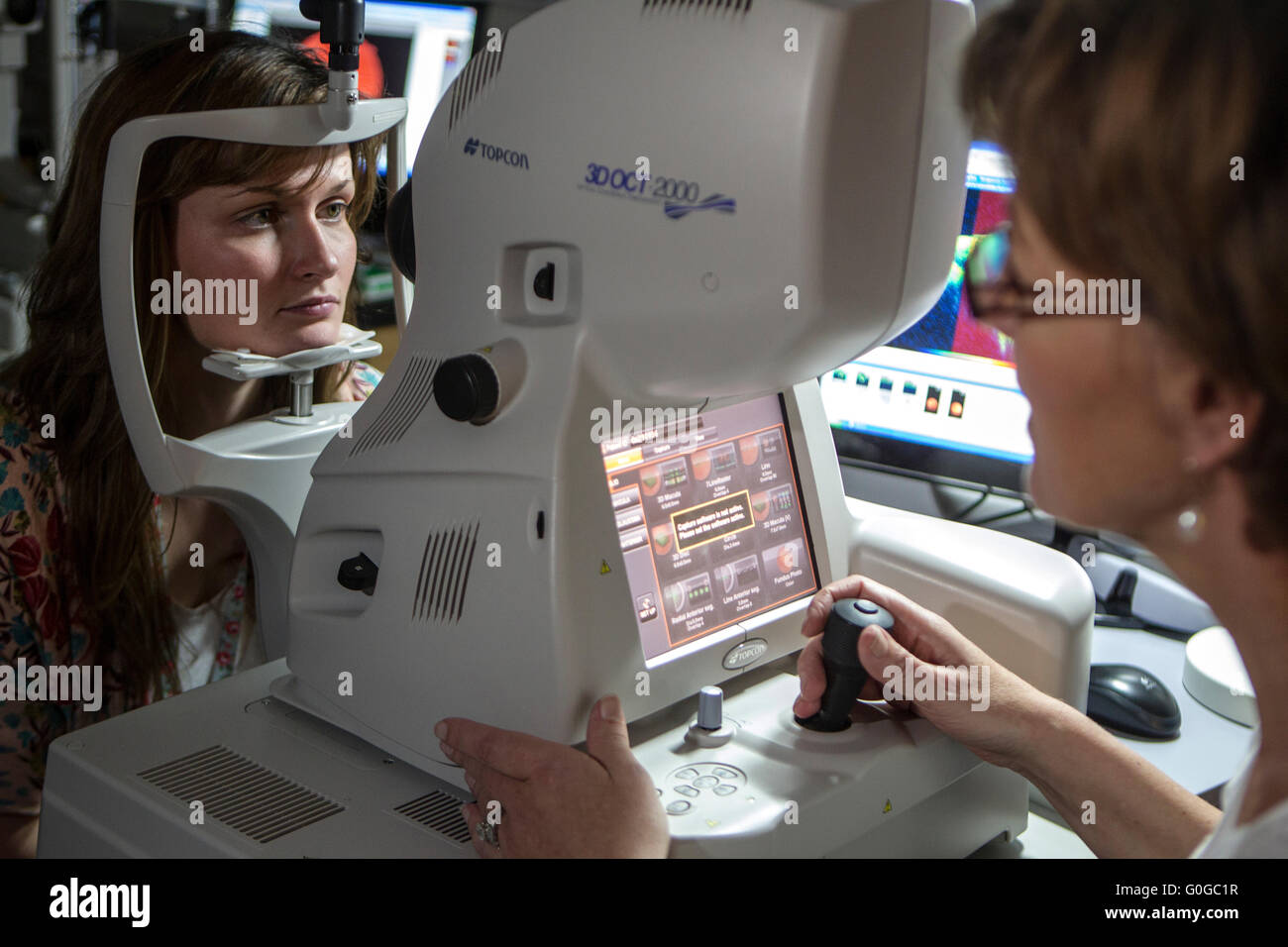 Optician examining womans vision Stock Photo