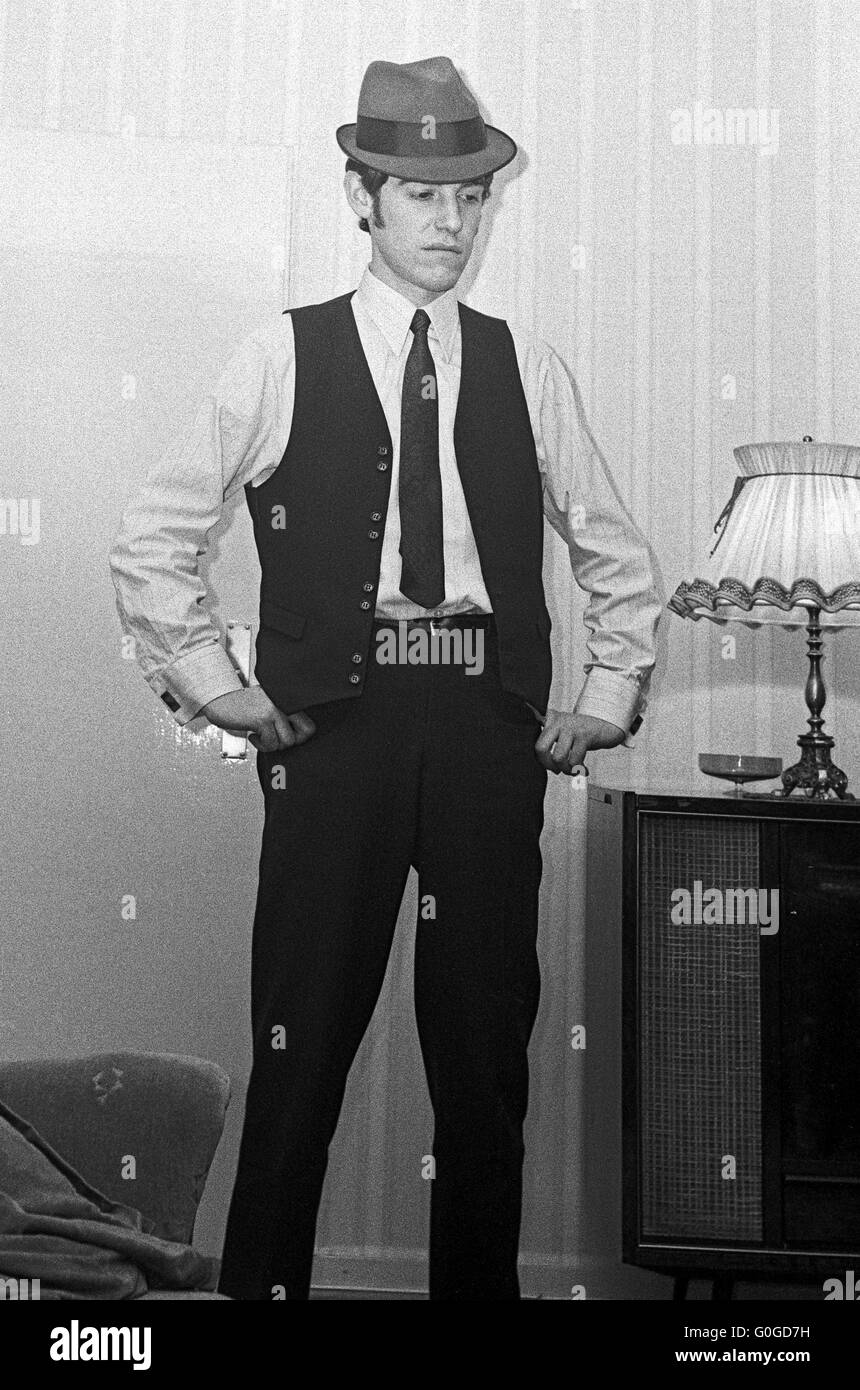 Siebziger Jahre, junger Mann mit Hut, Weste und Krawatte im Wohnzimmer, 18 bis 25 Jahre Stock Photo