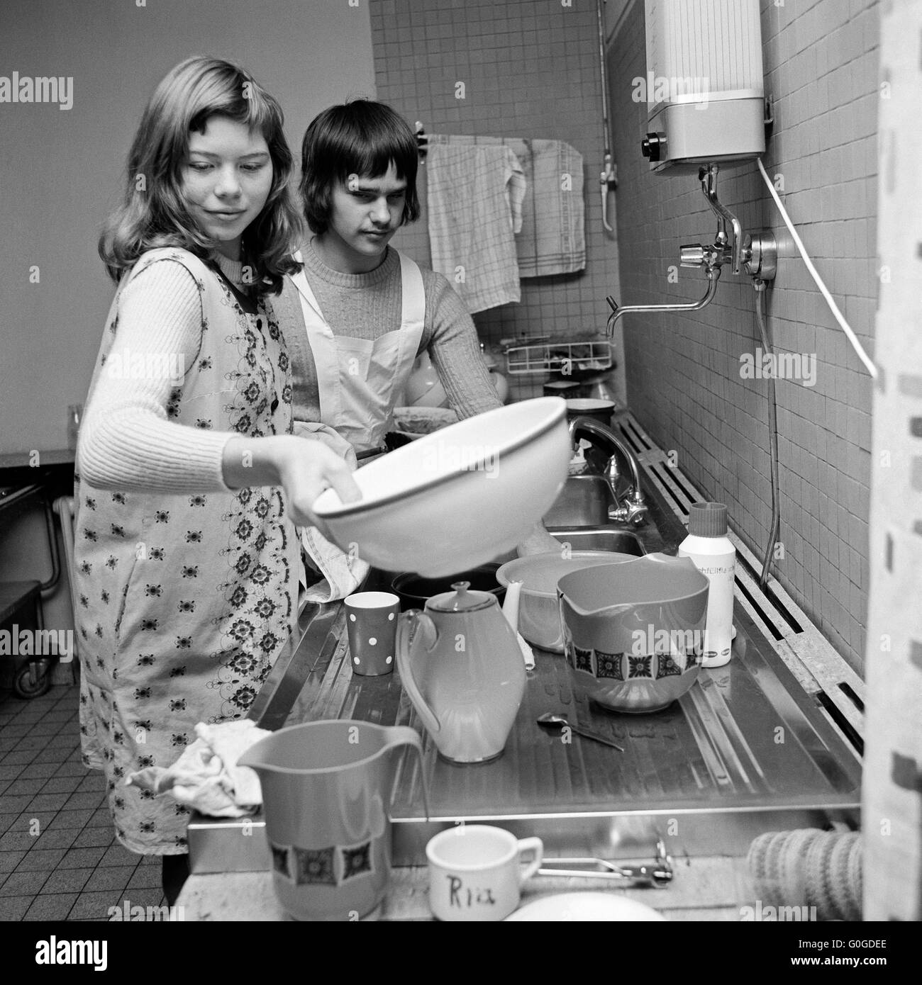 Seventies, black and white photo, people, physical handicap, school, school lessons, cooking instruction, schoolgirl 12 to 14 years and schoolboy 13 to 15 years doing the washing-up in the kitchen, Special School Alsbachtal, D-Oberhausen, D-Oberhausen-Sterkrade, Ruhr area, Lower Rhine, Rhineland, North Rhine-Westphalia, NRW Stock Photo