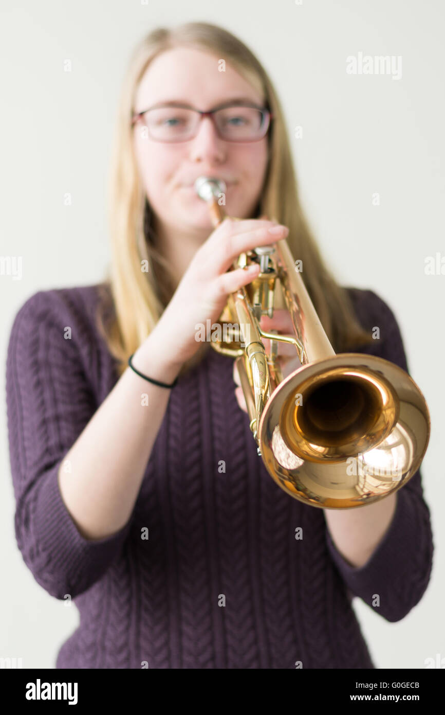 Teenager playing trumpet - Focus point instrument Stock Photo