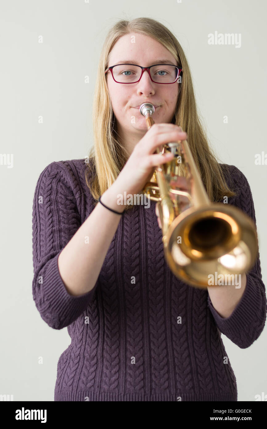 Girl playing trumpet into microphone - Stock Image - F005/1164 - Science  Photo Library