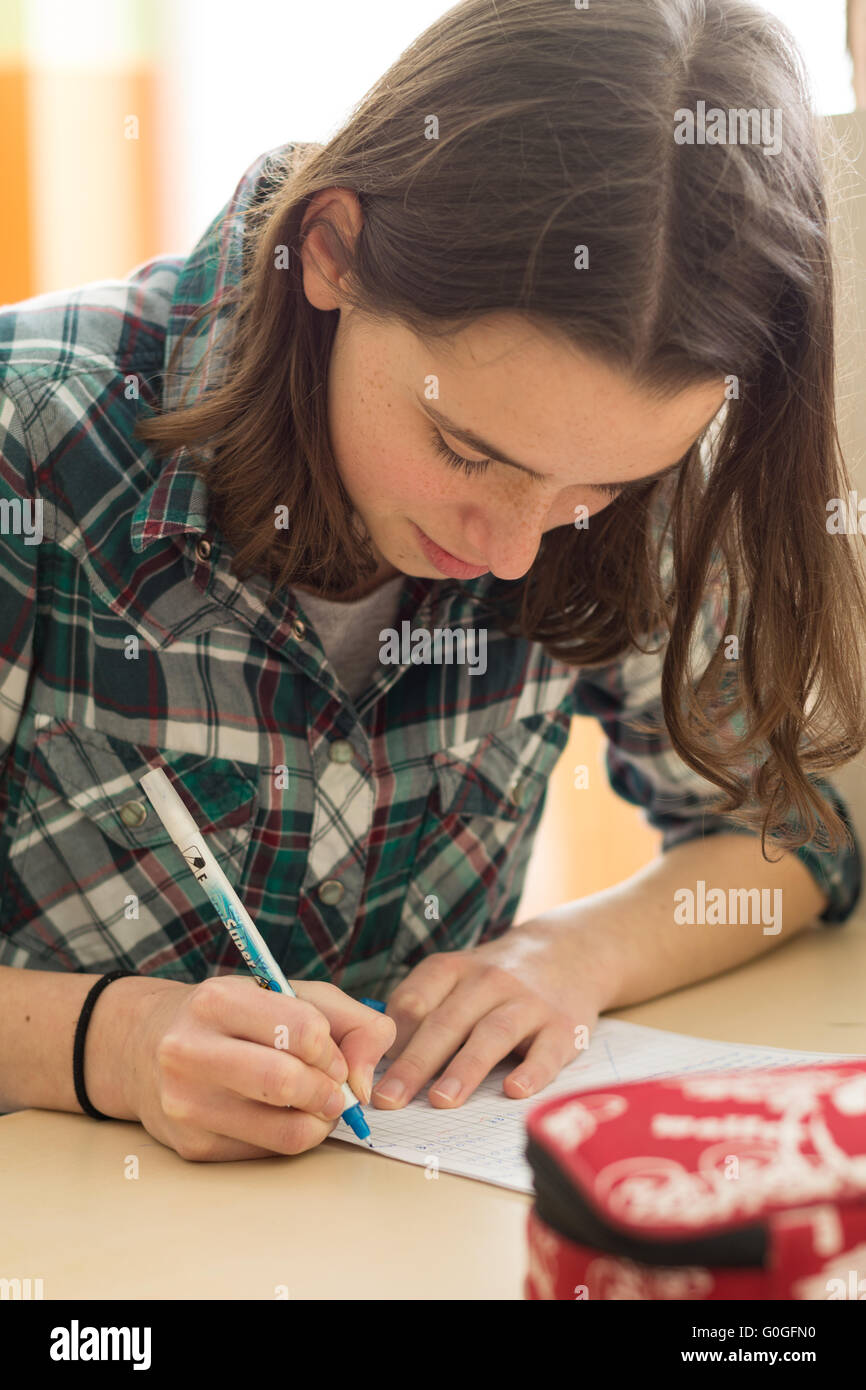 Teenager makes in the classroom a test - closeup Stock Photo