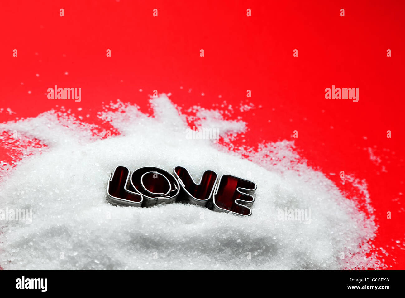Love text message from cookie form letters on sugar and red background. Valentines Day theme Stock Photo