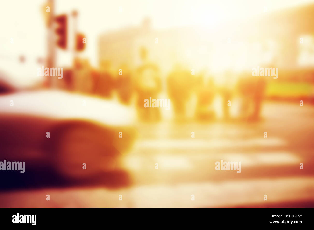 People about to cross the street. Car on the road. Blur background Stock Photo