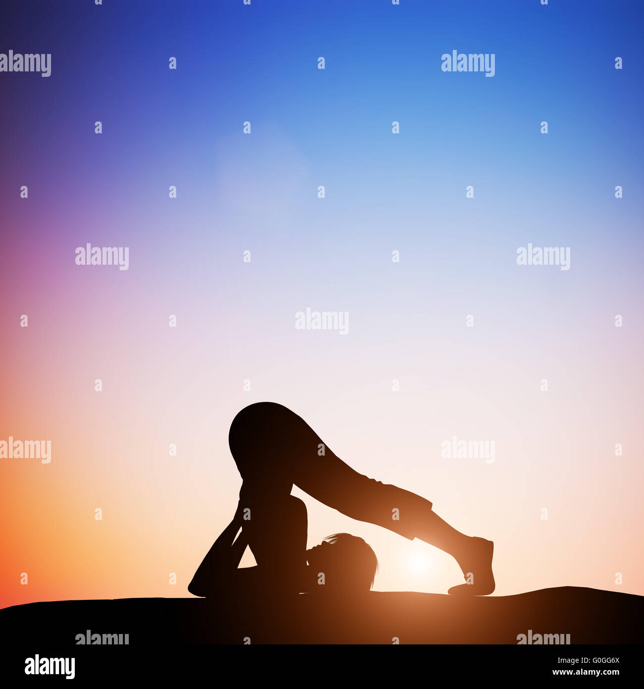 Woman in plow yoga pose meditating at sunset. Zen Stock Photo