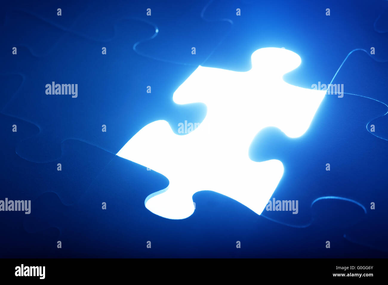 Jigsaw puzzle piece missing. Light glow from empty space. Search for