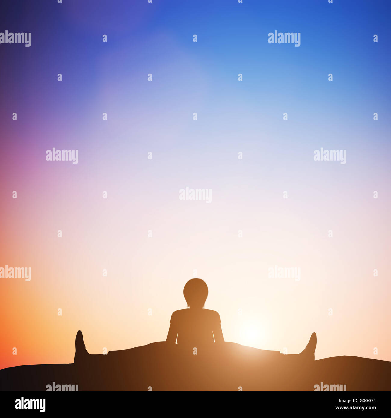 Woman in wide angle bend yoga pose meditating at sunset. Zen Stock Photo