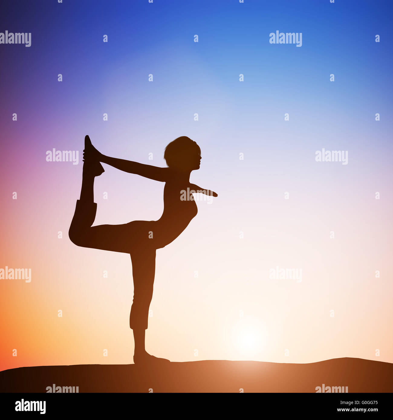 Woman in the dancer yoga pose meditating at sunset. Zen Stock Photo
