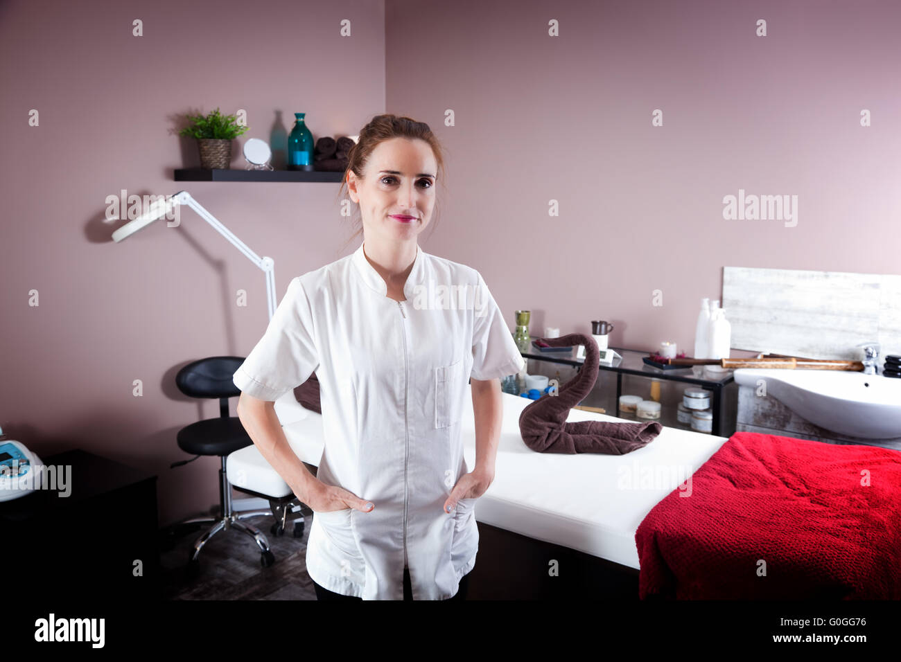 Female beautician in her new modern beauty and massage salon. Smiling and proud Stock Photo