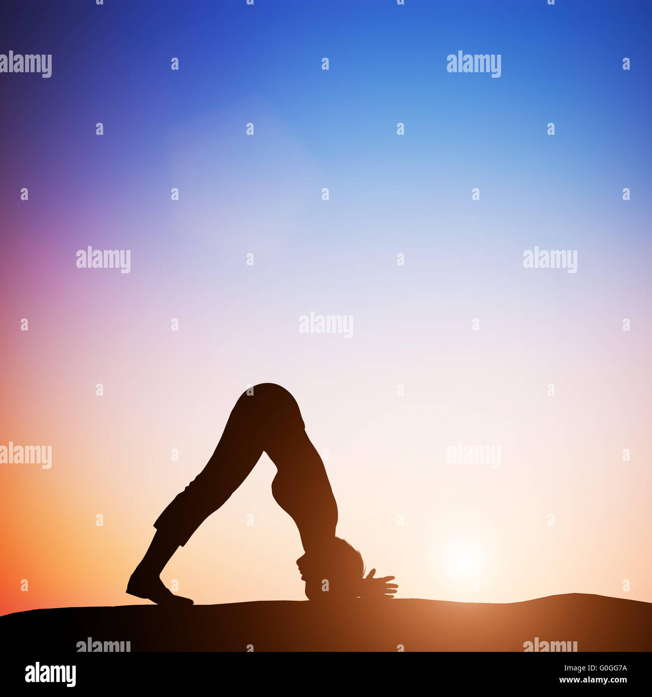 Woman in dolphin yoga pose meditating at sunset. Zen Stock Photo
