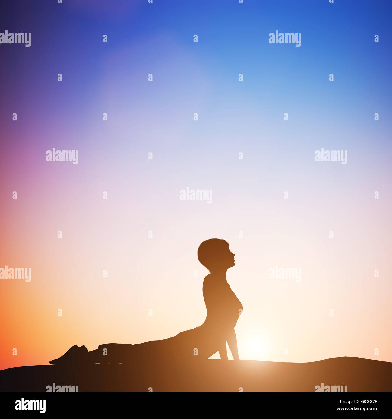 Woman in cobra yoga pose meditating at sunset. Zen Stock Photo