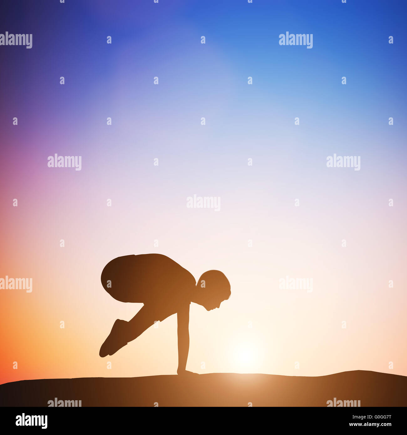 Woman in crane pose yoga pose meditating at sunset. Zen Stock Photo