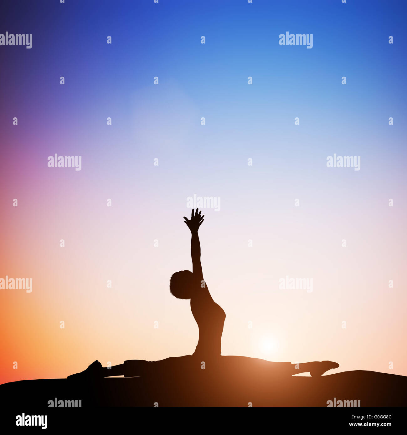 Woman in monkey yoga pose meditating at sunset. Zen Stock Photo