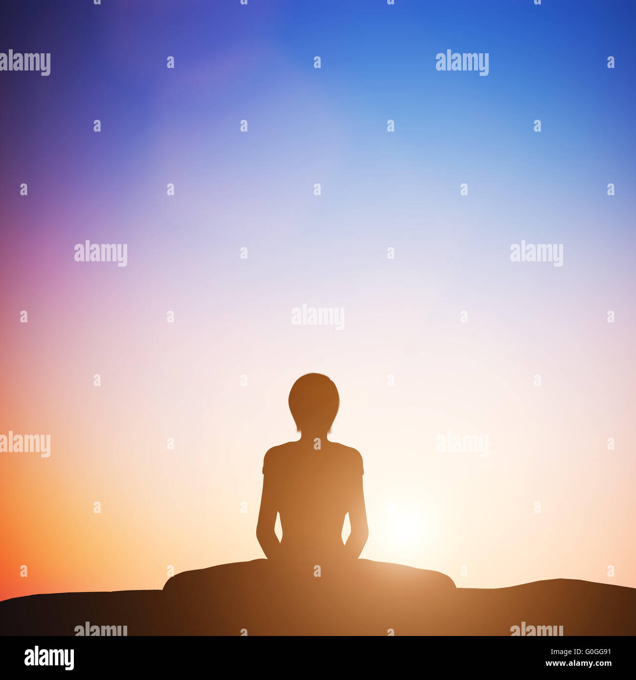 Woman in bound angle yoga pose meditating at sunset. Zen Stock Photo