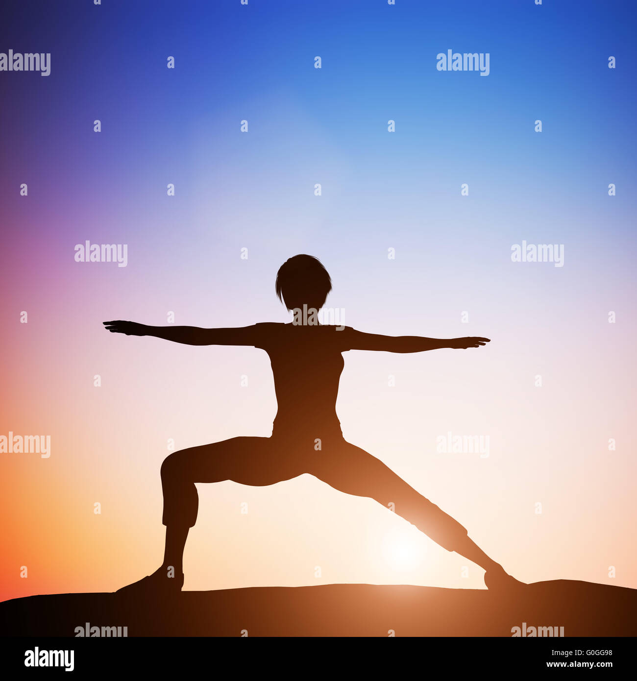 Woman in warrior yoga pose meditating at sunset. Zen Stock Photo
