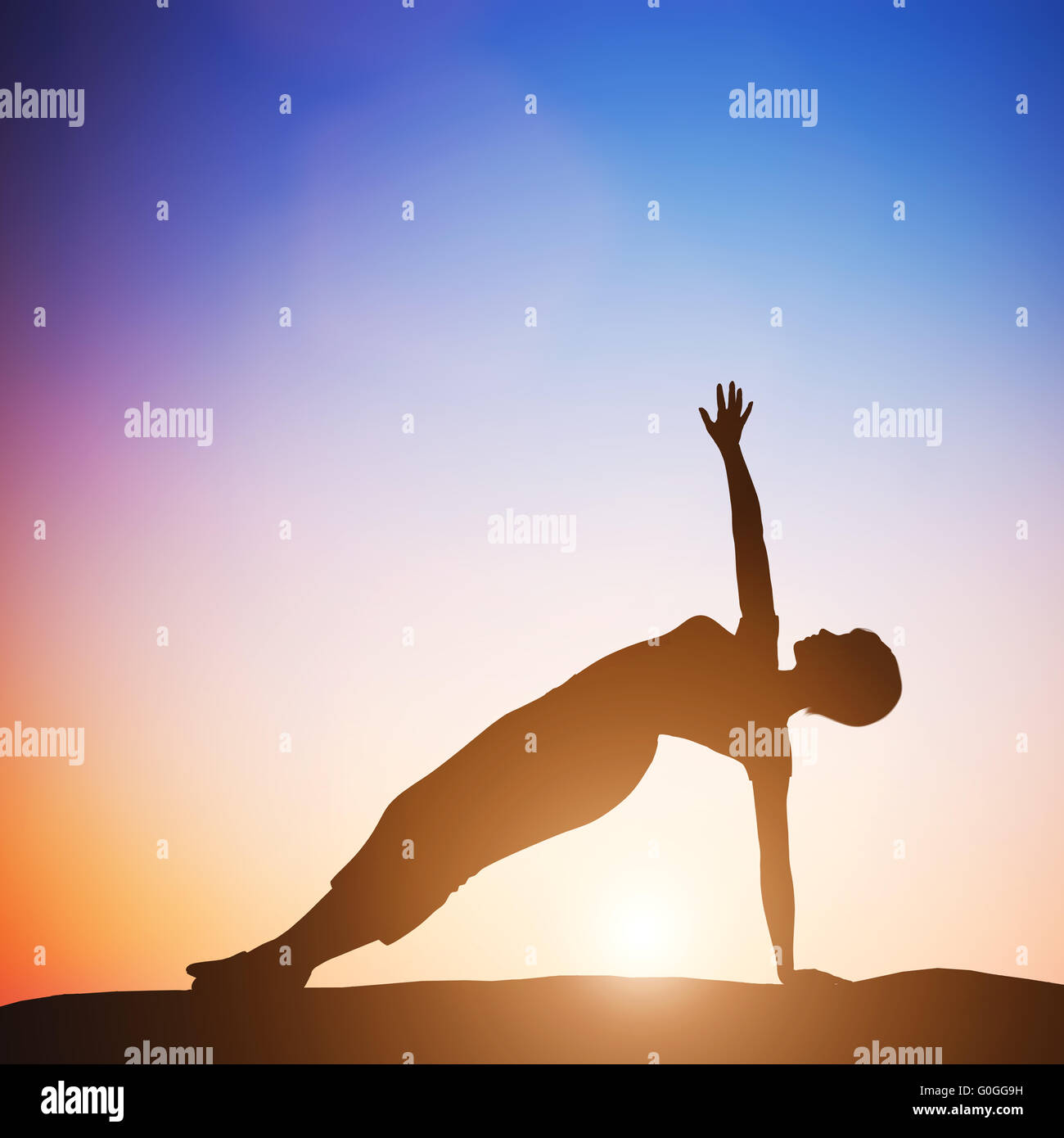 Woman in side balance yoga pose meditating at sunset. Zen Stock Photo
