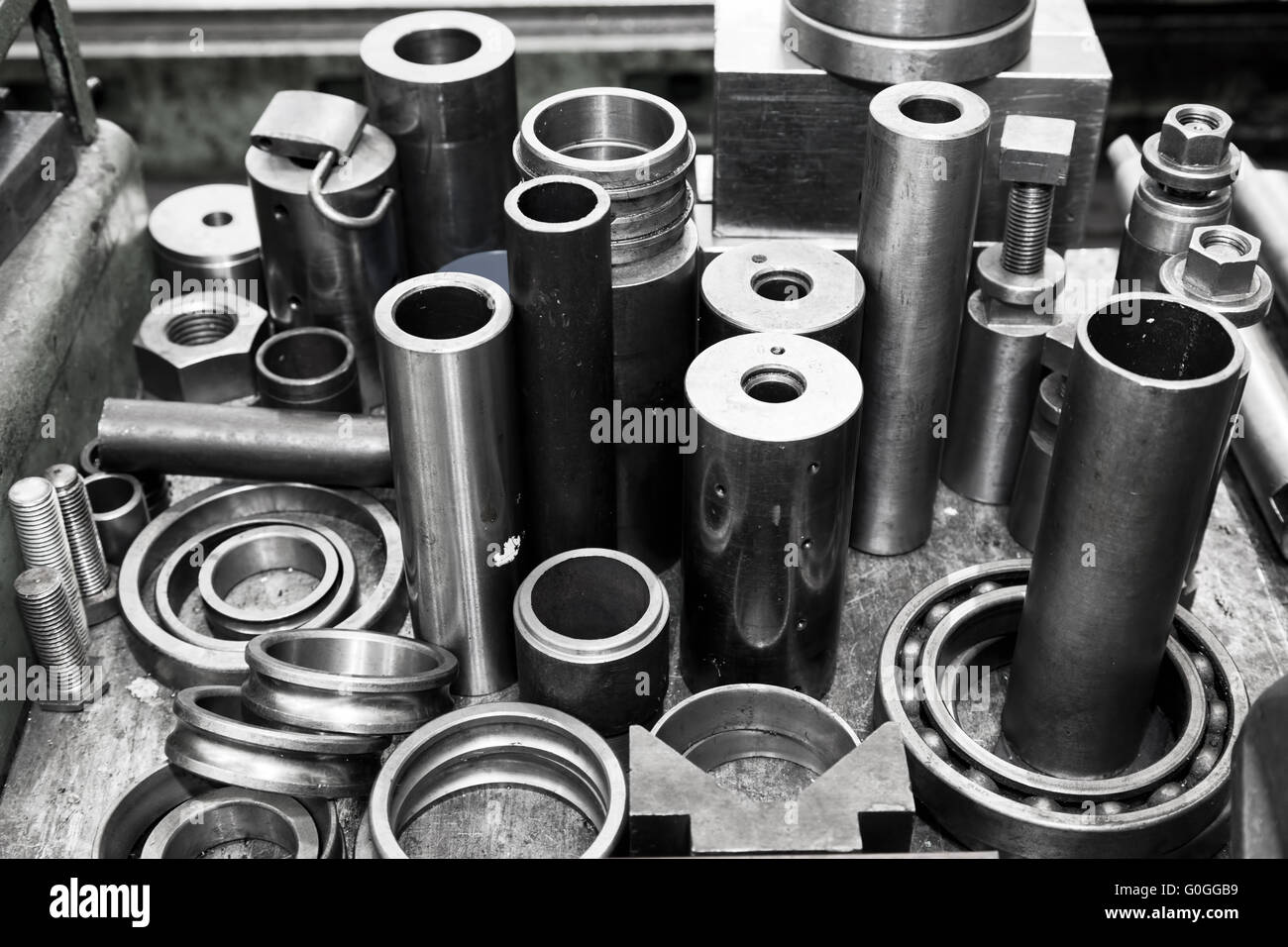 Steel cylinders, pistons and tools in workshop. Industry theme. Stock Photo