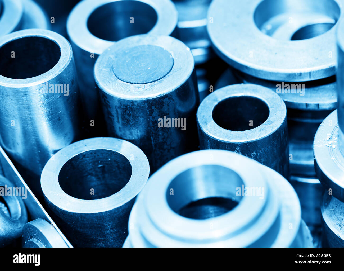 Steel cylinders, pistons and tools in workshop. Industry theme. Stock Photo