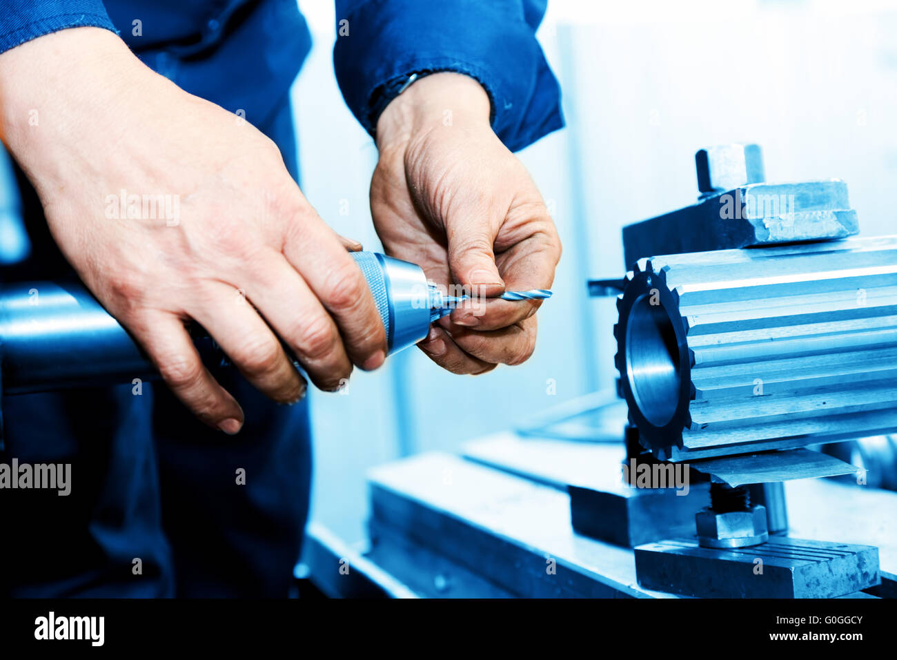Man working on drilling and boring machine. Industry Stock Photo