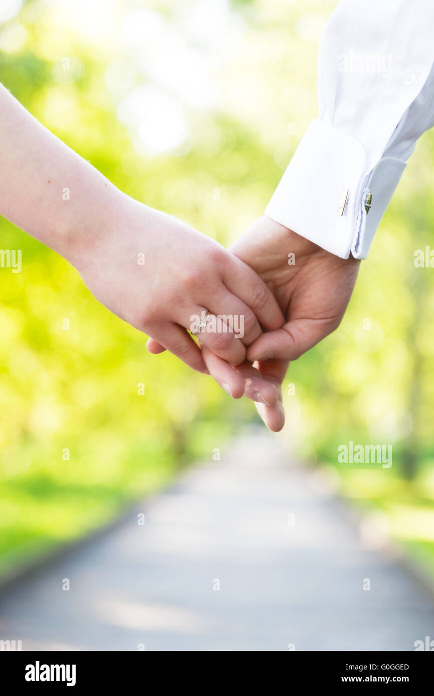 Holding hands close-up. Couple in love dating Stock Photo
