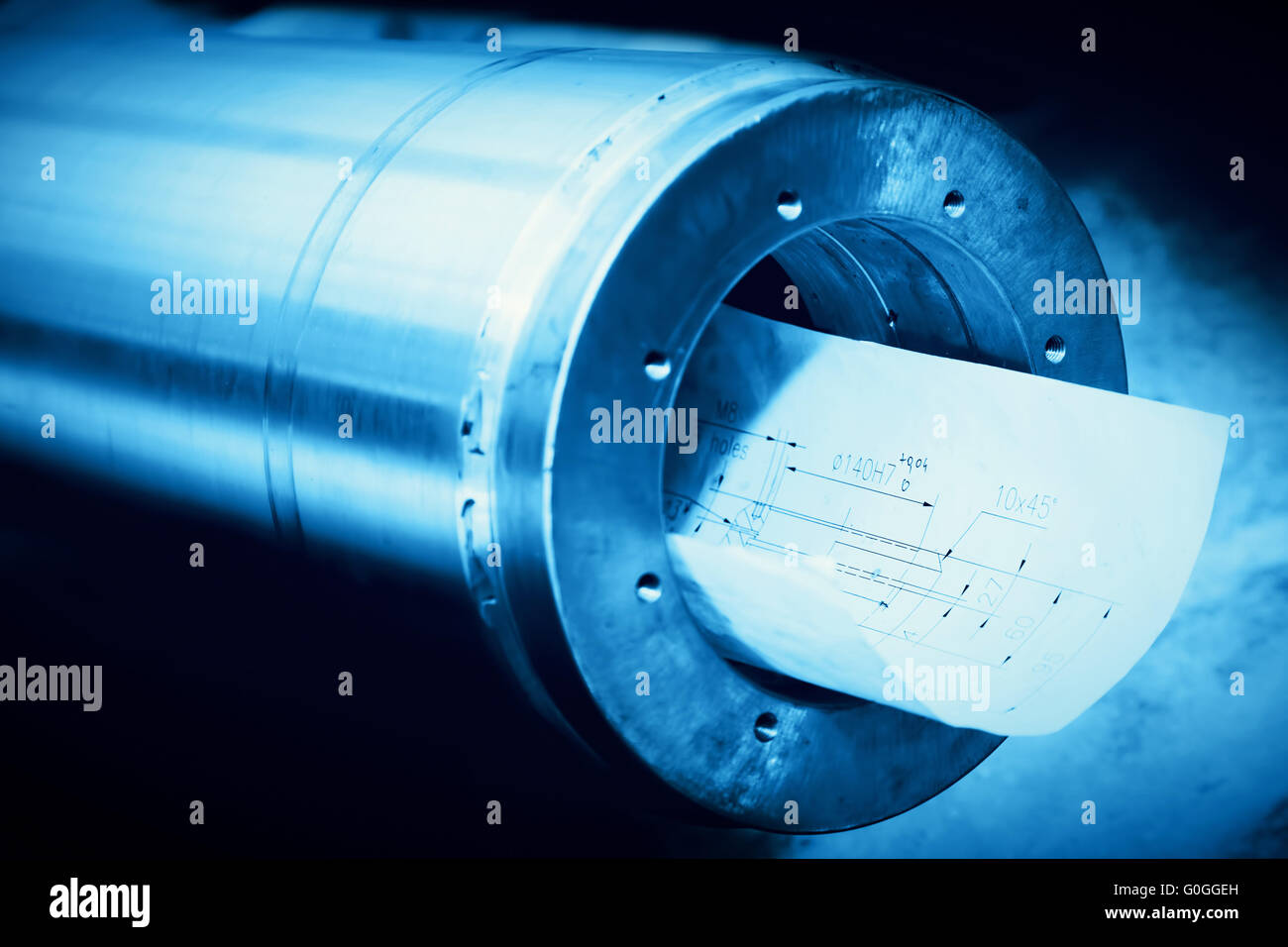 Heavy industry steel cylinder, piston with industrial plans. Stock Photo