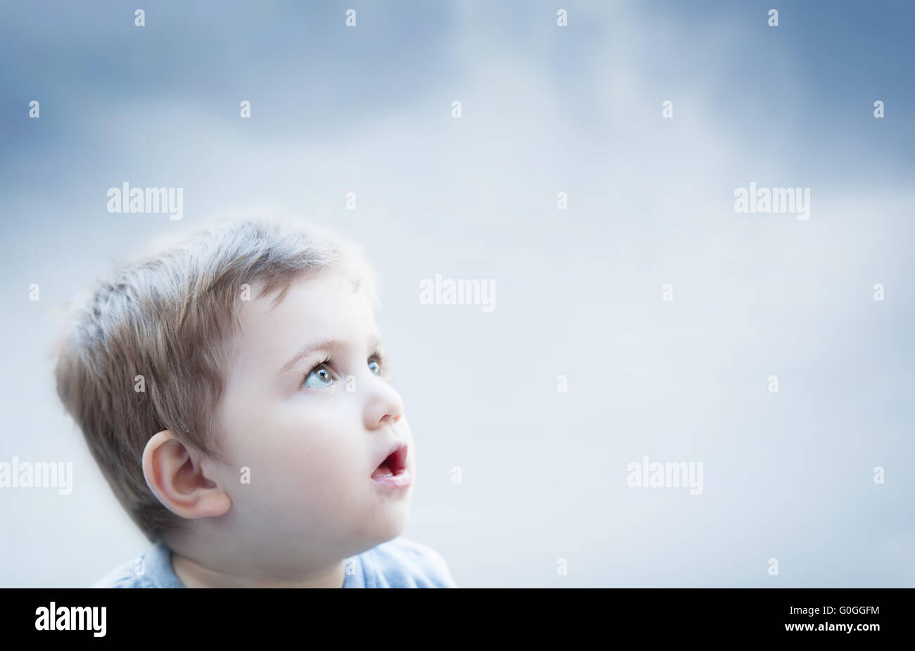 Boy looking at the sky with surprised expression. Child imagination Stock Photo