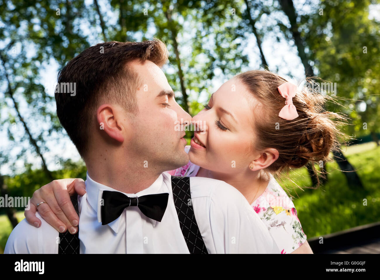 Young romantic couple in love flirting in summer park. Stock Photo