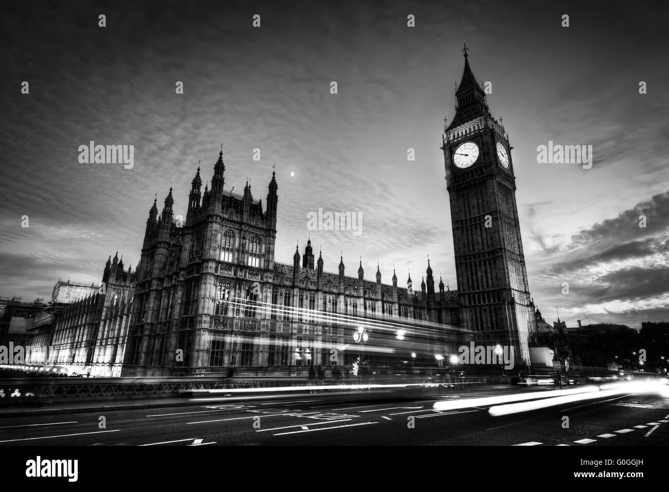 Red bus, Big Ben and Westminster Palace in London, the UK. at night. Black and white Stock Photo