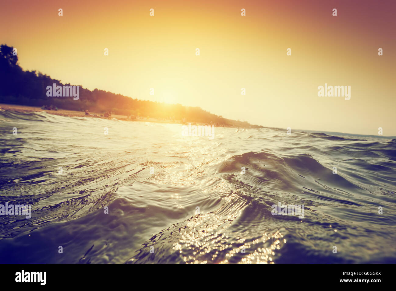 Sea waves and ripples at sunset. First person perspective swimming Stock Photo