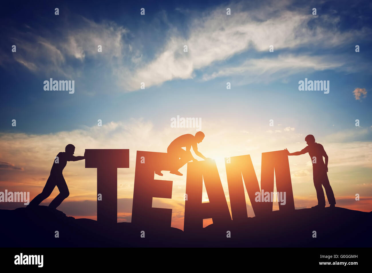 People connect letters to compose the team word. Teamwork concept Stock Photo