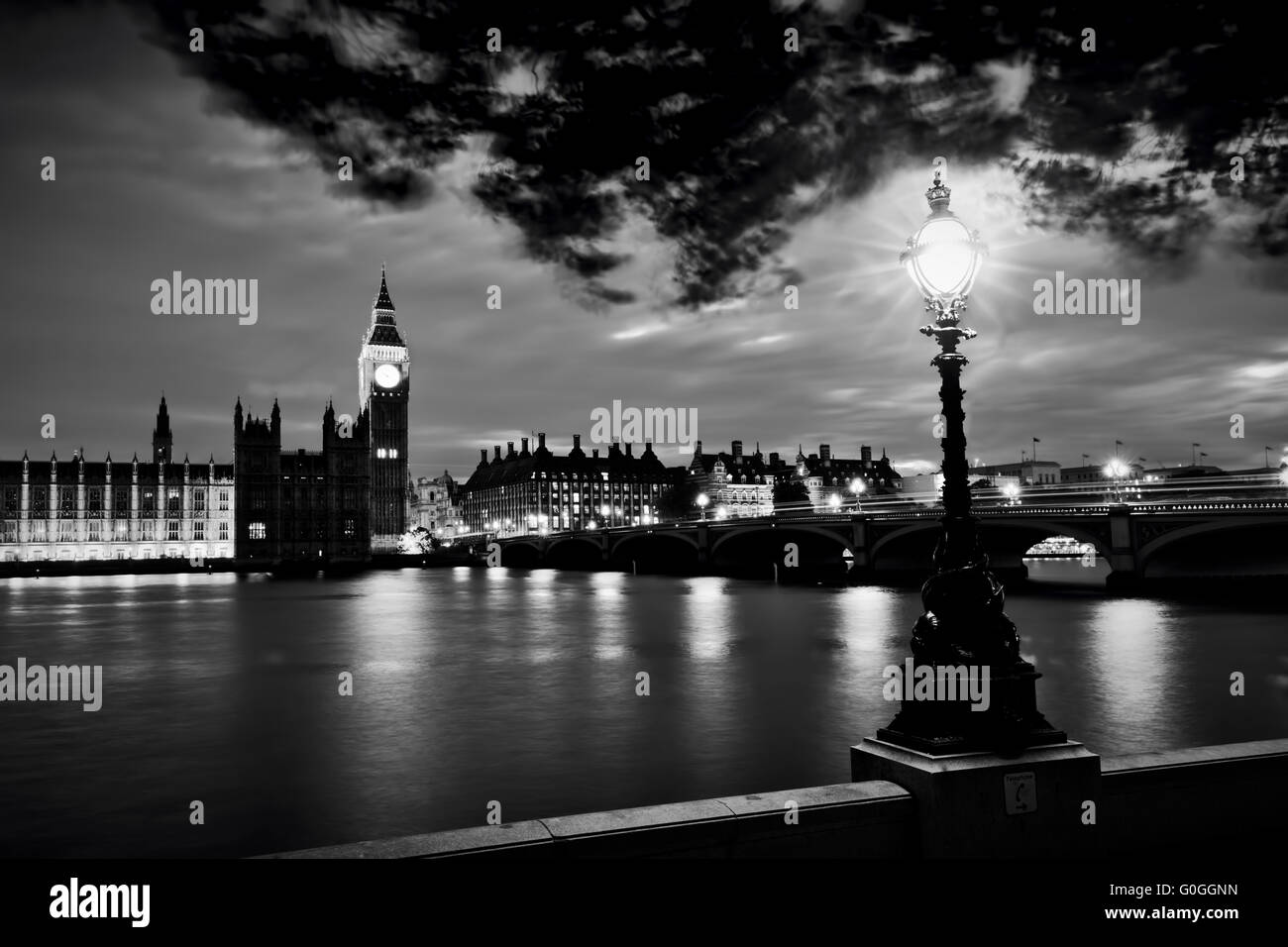 Big Ben, London the UK at sunset. Retro street lamp light on Westminster Bridge. Black and white Stock Photo