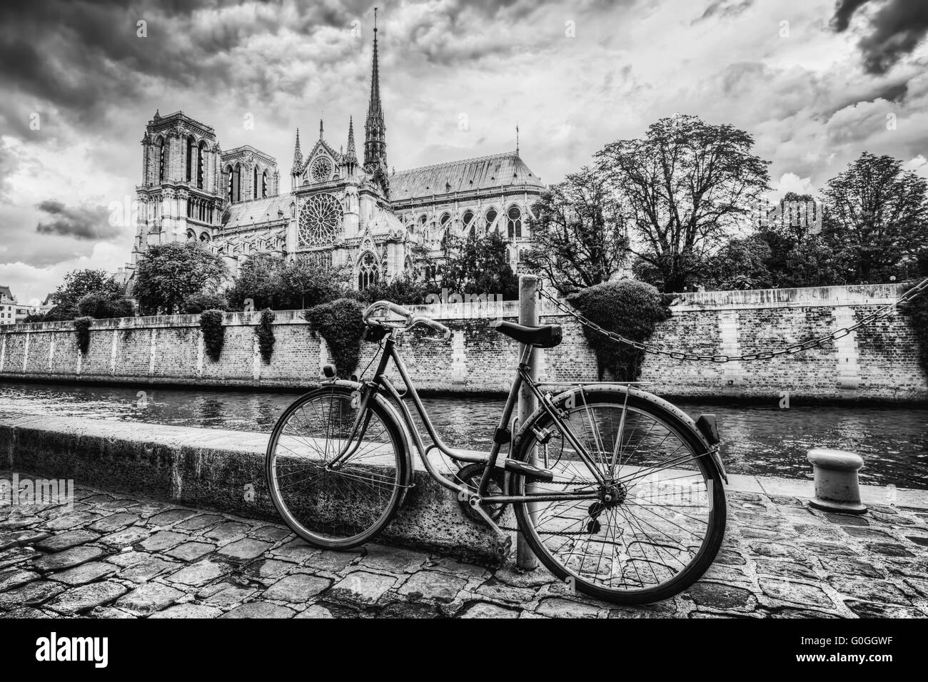 Retro bike next to Notre Dame Cathedral in Paris, France. Black and white Stock Photo