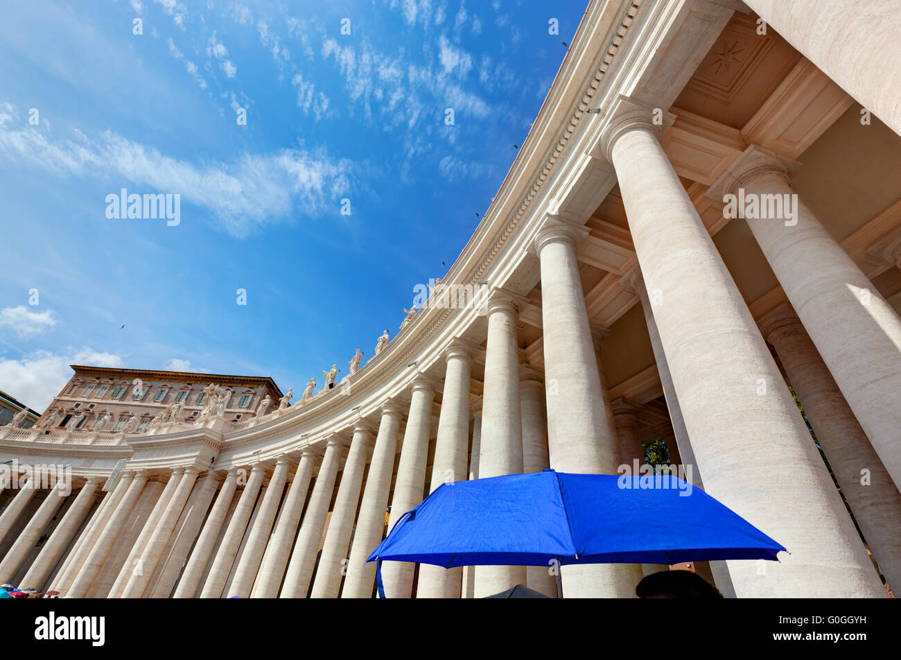 St. Peter#39;s Basilica colonnades in Vatican City. Blue umbrella harmonizes with sky Stock Photo