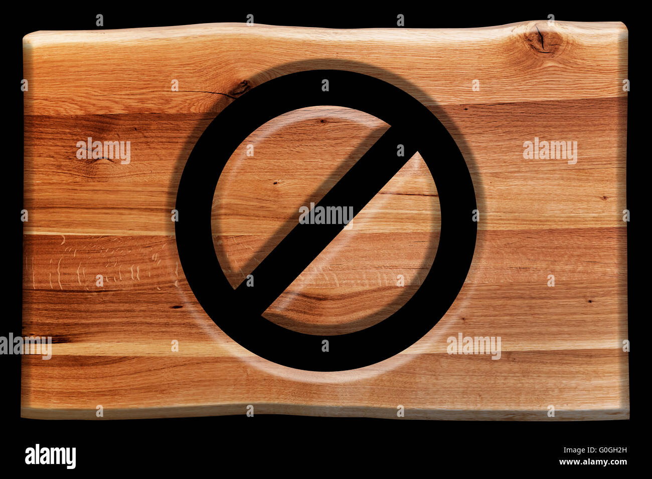 Prohibition, ban or closed symbol cut in wooden board isolated on black Stock Photo