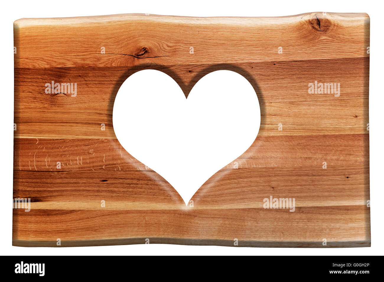 Heart shape cut in a wooden board isolated on white. Love symbol Stock Photo