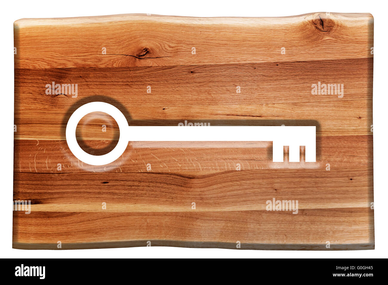 Key symbol cut in wooden board isolated on white Stock Photo