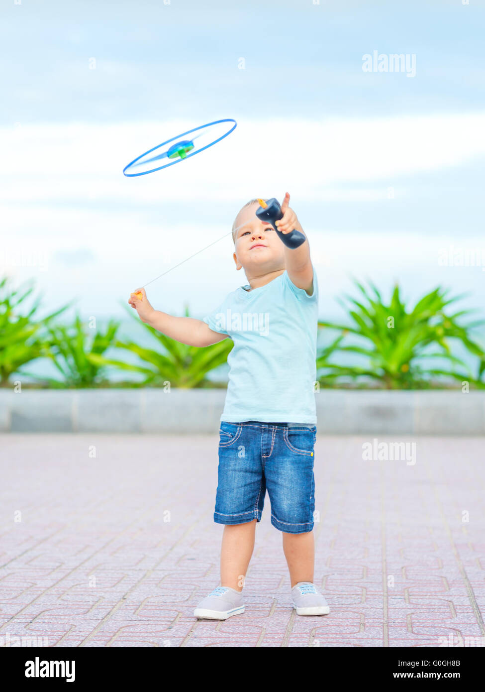 Baby with flying saucer Stock Photo Alamy