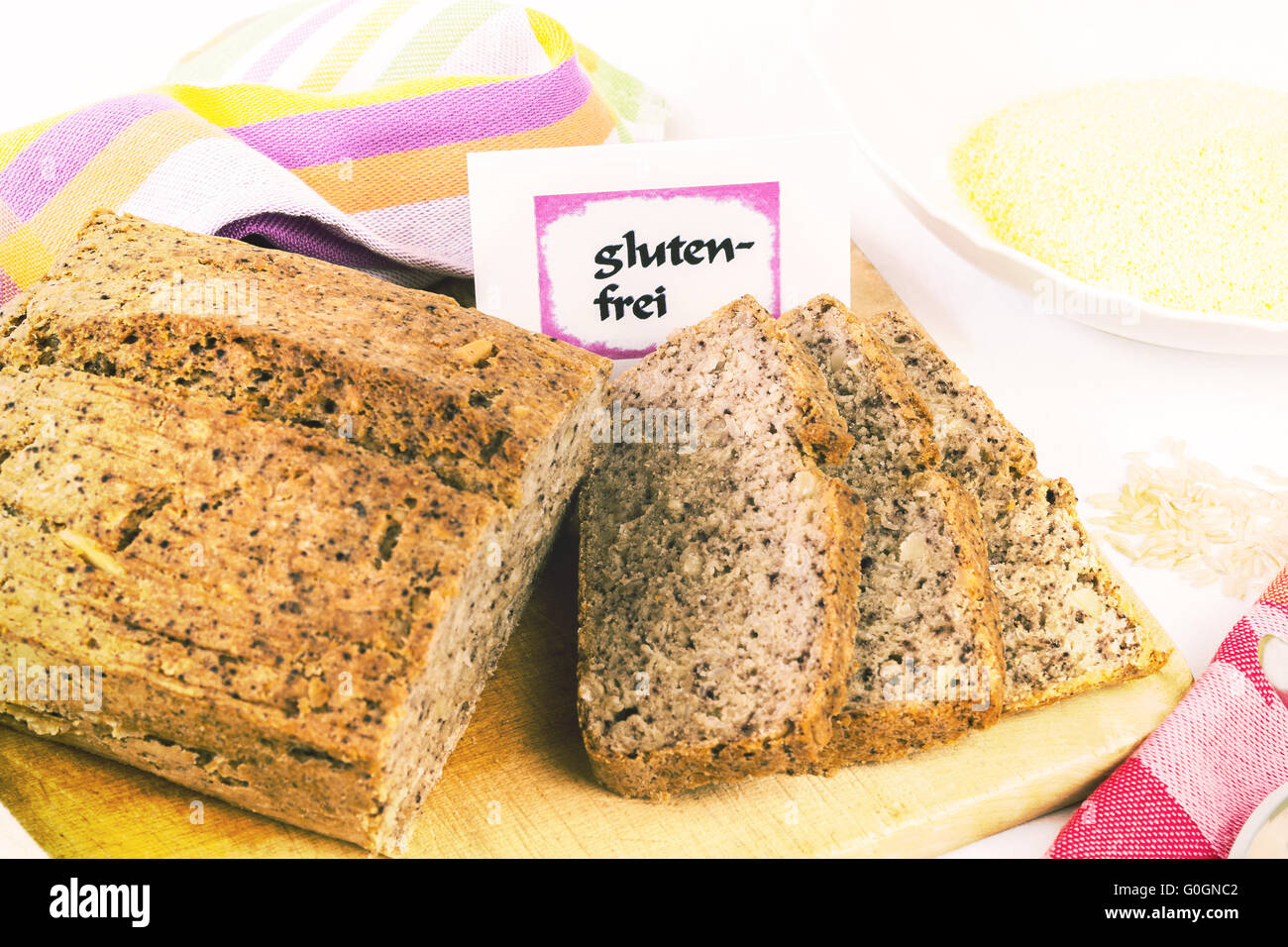 Wooden board with homemade, gluten-free wholemeal bread from rice and corn, isolated Stock Photo