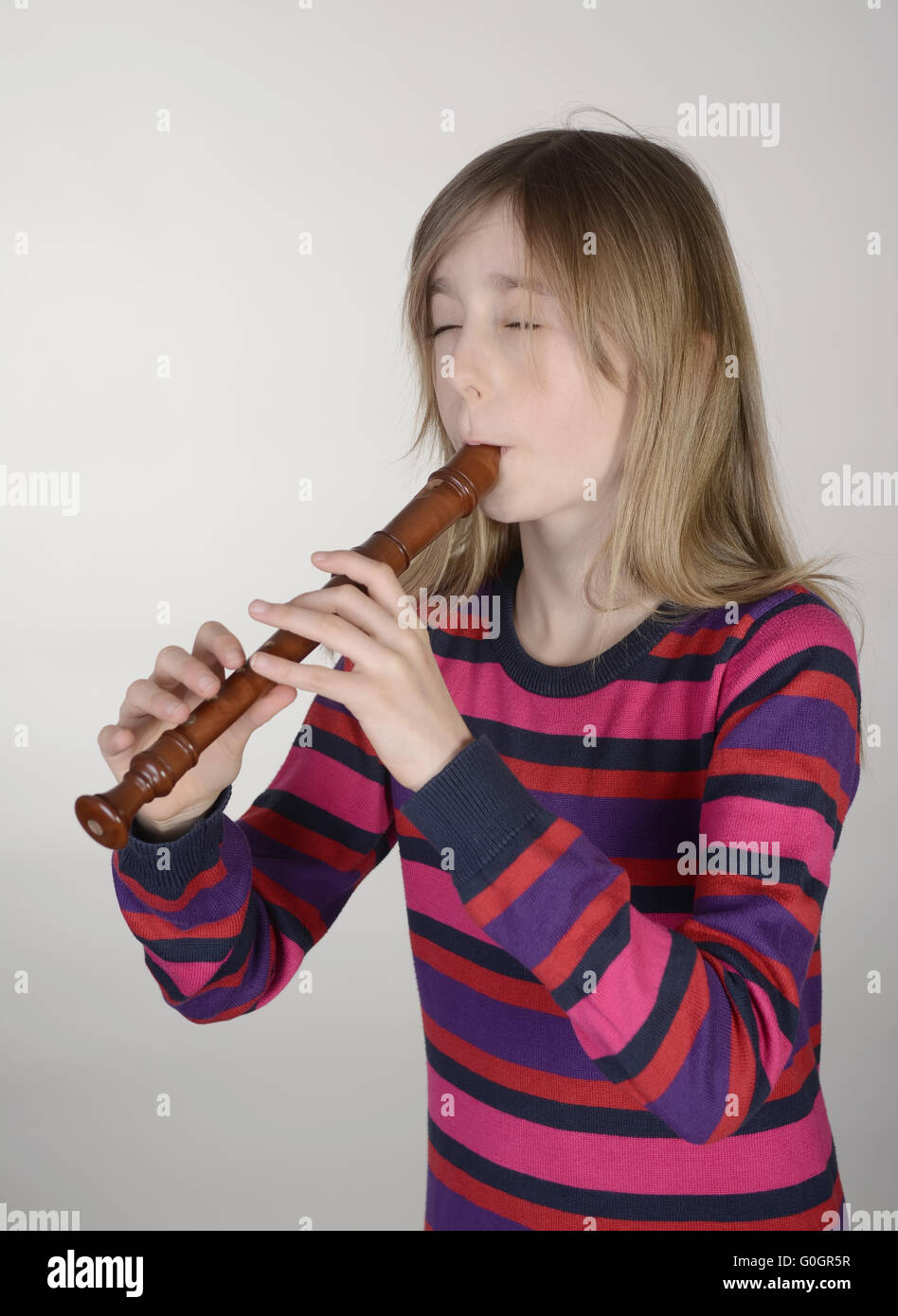 little girl playing recorder Stock Photo Alamy