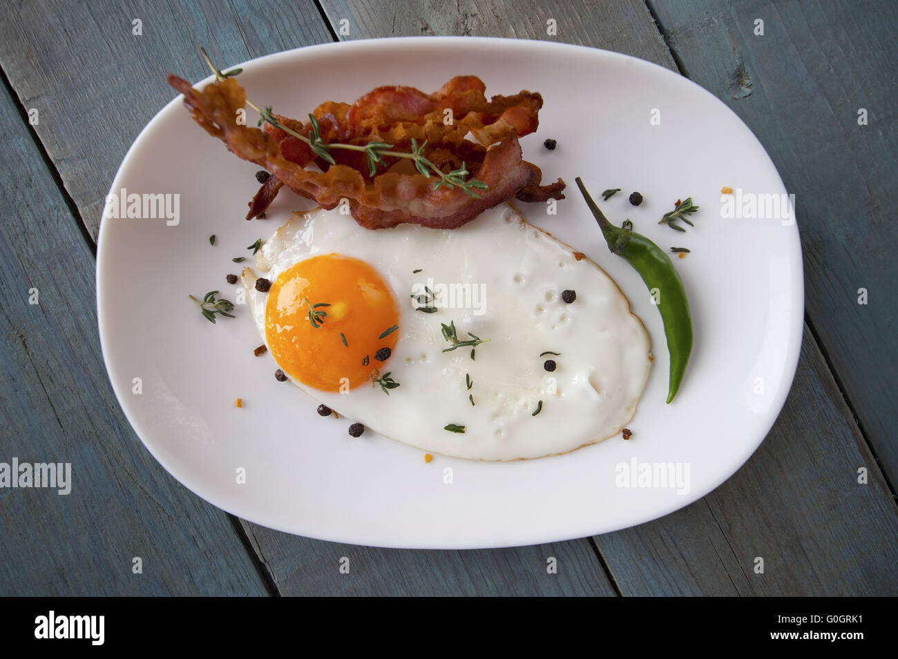Breakfast. Fried eggs and bacon on an oval plate. Stock Photo