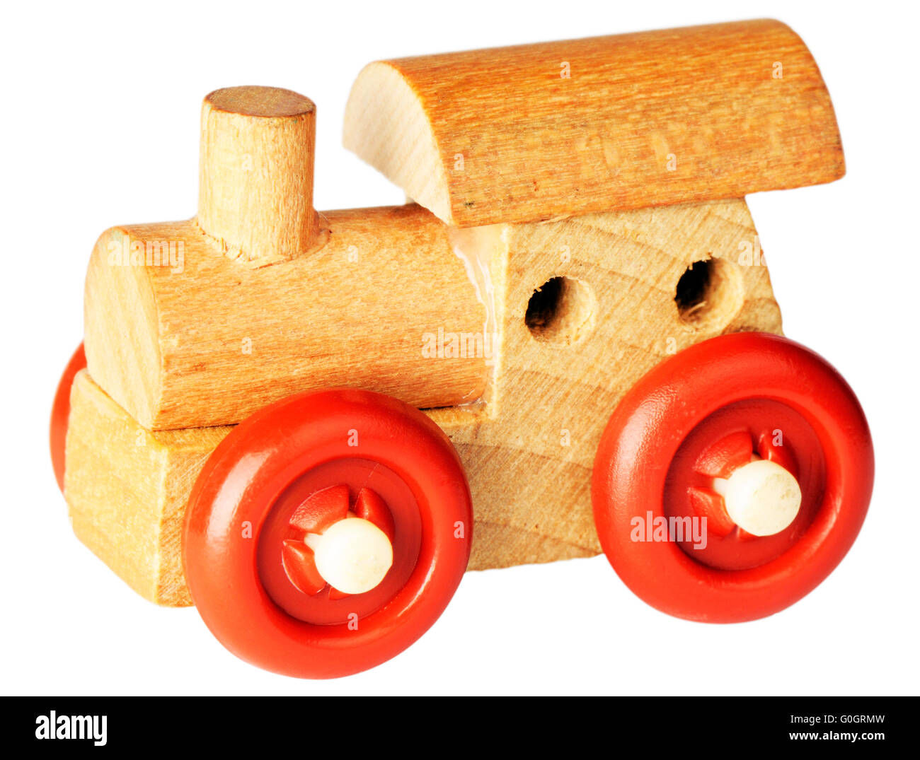 Wooden toy railway steam-engine with red wheels isolated on white Stock Photo