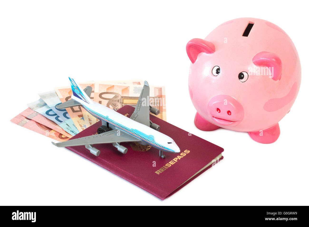 Passport with toy plane and piggy bank Stock Photo