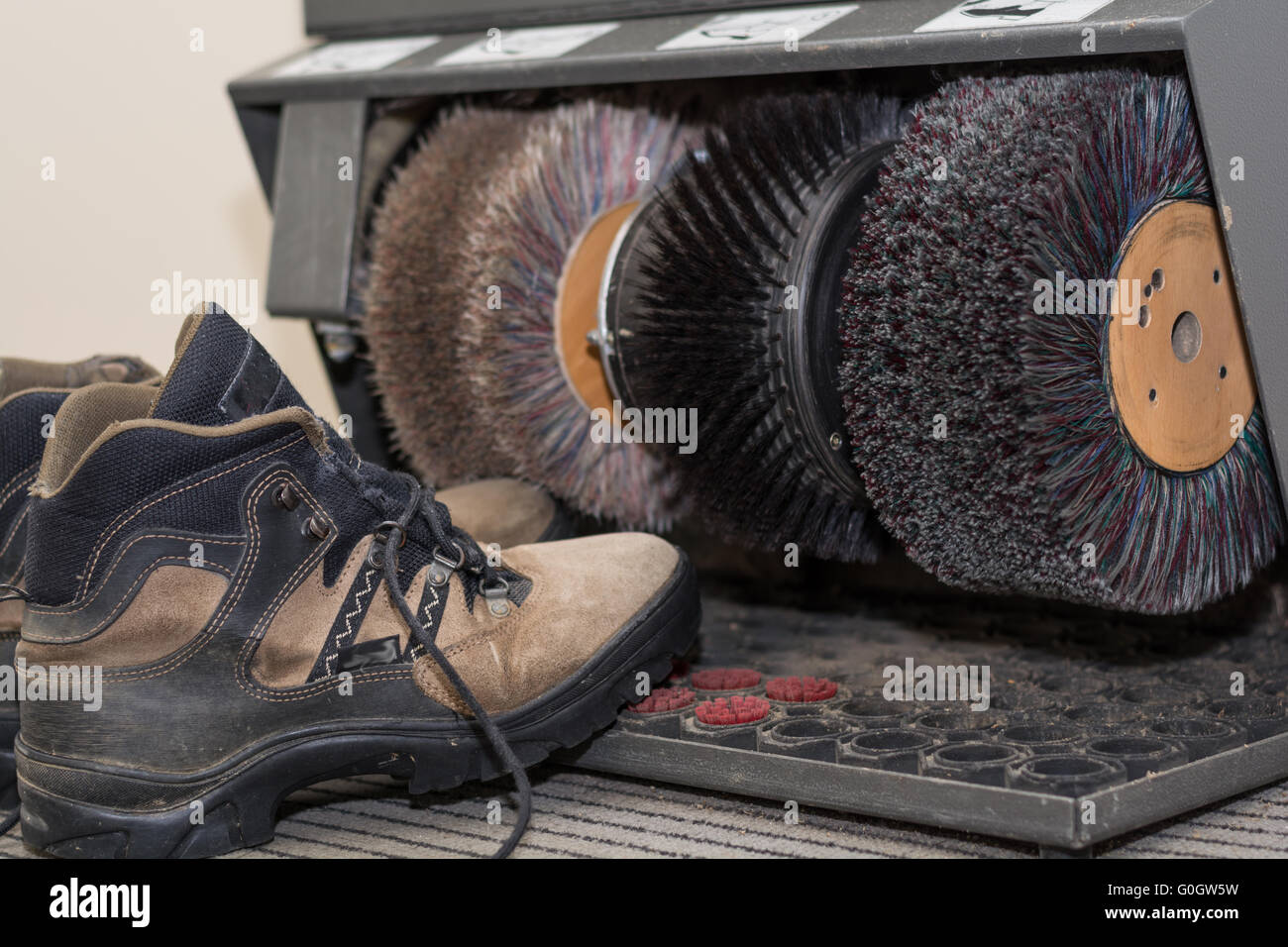 Walking shoes are in a Shoe polish machine Stock Photo
